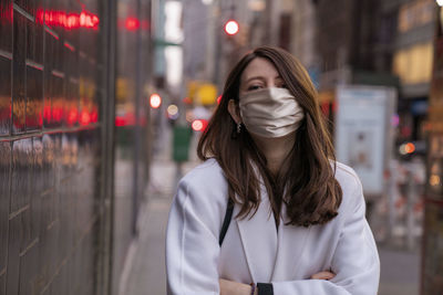 Portrait of beautiful woman standing on street in city