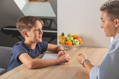 Man and son on table