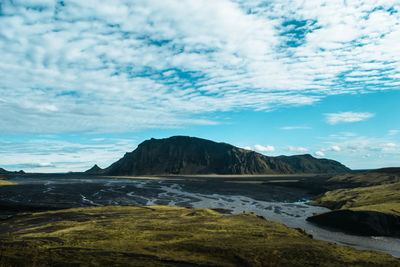 Scenic view of sea and mountains against sky