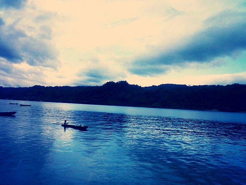 water, waterfront, nautical vessel, mountain, sky, tranquil scene, boat, tranquility, scenics, transportation, lake, beauty in nature, mode of transport, rippled, silhouette, nature, cloud - sky, sea, reflection, mountain range