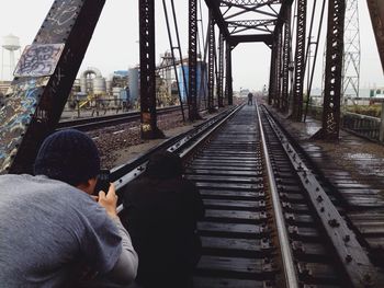 Men photographing at railroad track