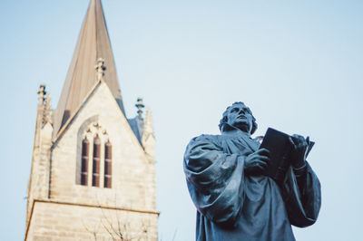 Low angle view of statue against sky