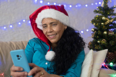 Portrait of smiling young man using smart phone