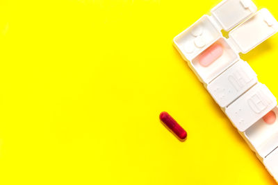 High angle view of usb stick on yellow background