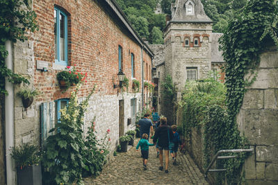 Rear view of people walking on wall