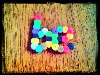 Close-up of colorful balls on wooden wall