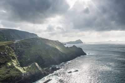 Scenic view of sea and mountains against sky