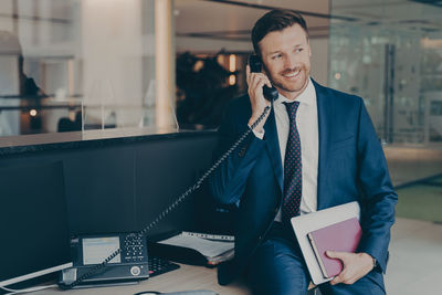 Portrait of young businesswoman working at desk in office