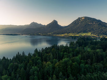 Scenic view of lake and mountains against clear sky