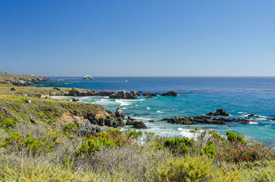 Scenic view of sea against clear blue sky