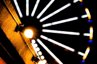 Low angle view of illuminated lamp post at night