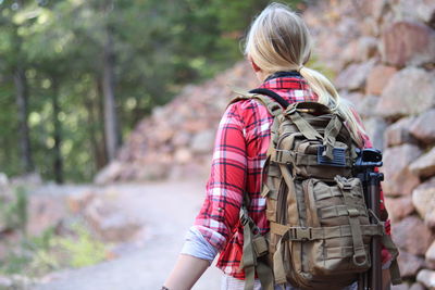 A young woman hikes through the mountains