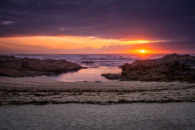 Beautiful sunset rock beach landscape peaceful relaxing with waves crashing atlantic ocean in spain