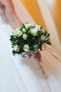 Bride holding rose bouquet in wedding ceremony