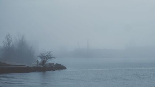 Scenic view of sea against sky at foggy weather