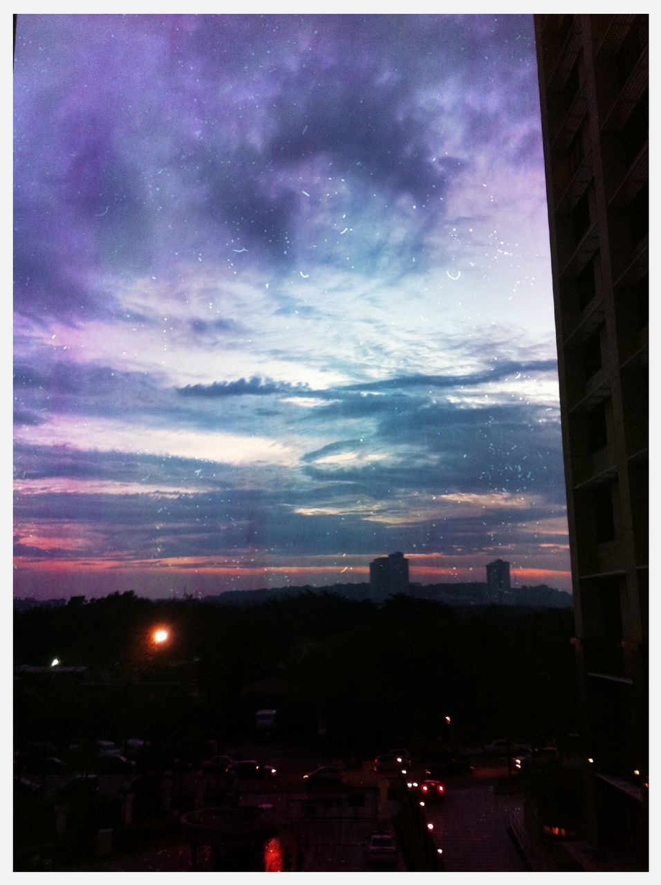 sky, transfer print, building exterior, architecture, built structure, cloud - sky, city, auto post production filter, illuminated, dusk, cloudy, silhouette, sunset, weather, cloud, night, street, cityscape, road, overcast