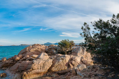 Rock formations by sea against sky