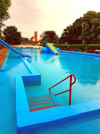 High angle view of swimming pool against blue sky