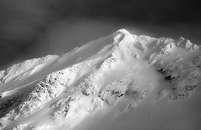 Scenic view of snow covered mountains against sky