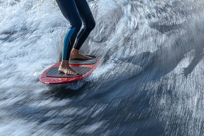 Legs of woman wakesurfing in moskva river