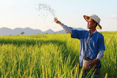 Man standing in farm against sky