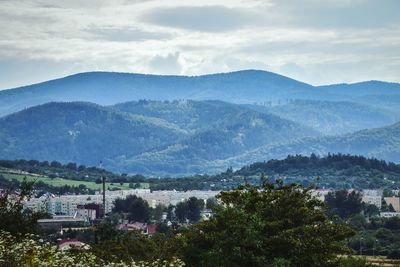 High angle view of mountains against cloudy sky