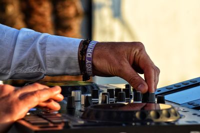 Midsection of man working at music concert