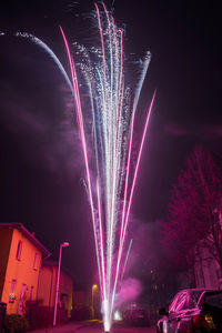 Low angle view of firework display at night