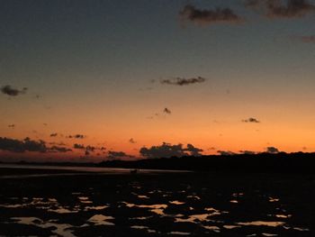 Scenic view of silhouette field against sky during sunset