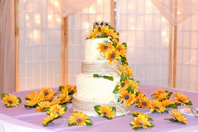Close-up of orange flowers on cake over table