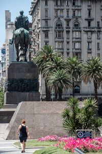 Statue against plants in city