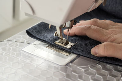 Close-up of woman sewing fabric