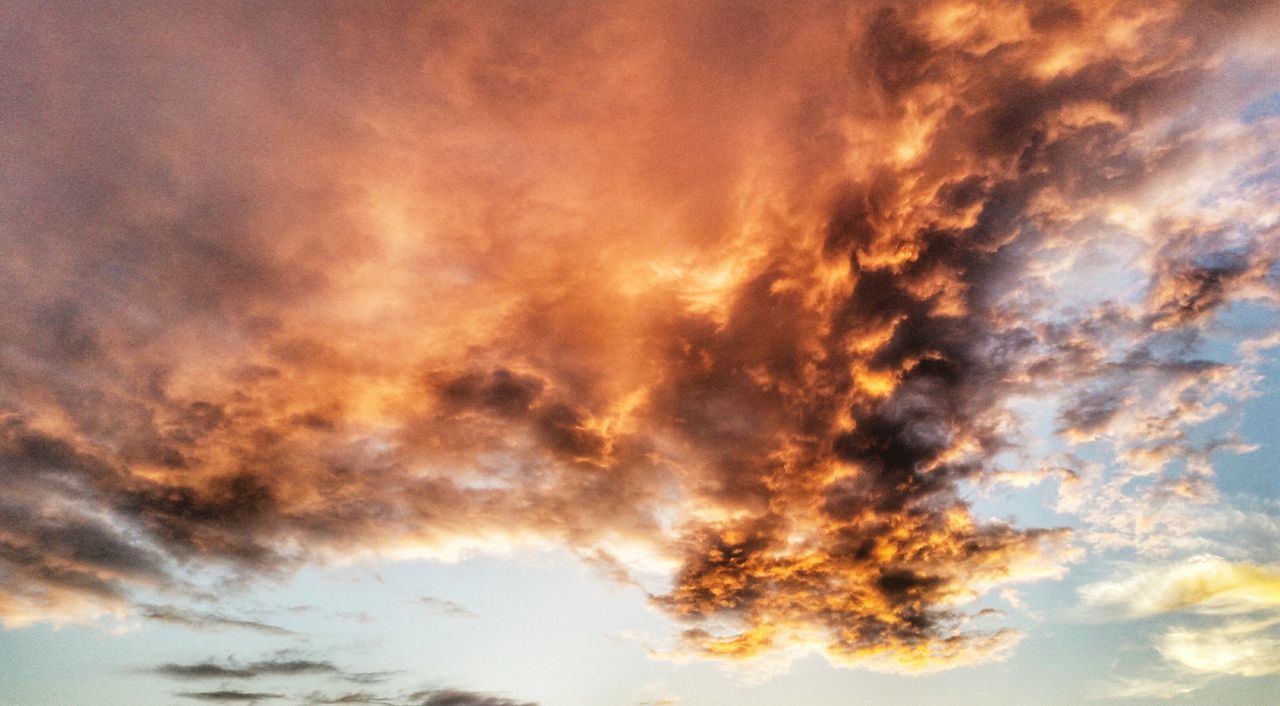 cloud - sky, sky, beauty in nature, dramatic sky, low angle view, nature, sunset, scenics, cloudscape, weather, tranquil scene, no people, sky only, outdoors, backgrounds, tranquility, yellow, day