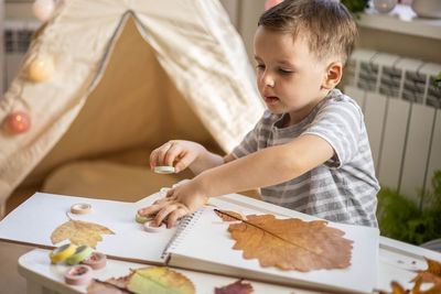 Boy drawing on bed at home