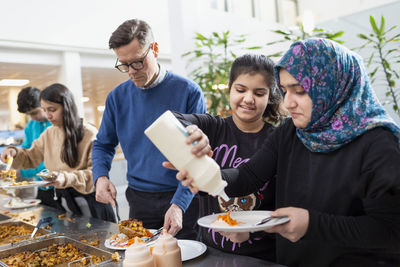 Teenagers choosing food in school canteen