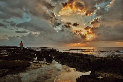 Man standing on coast looking at view