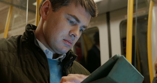 Portrait of young man looking through train