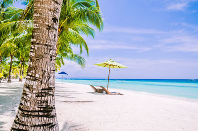 Scenic view of beach against blue sky