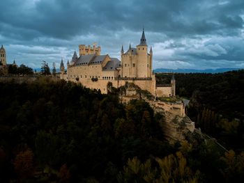 The alcazar of segovia a medieval castle with cloud sky and forest