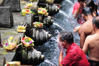 Worshippers in pond at temple