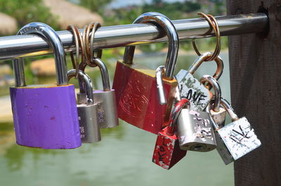 Close-up of padlocks hanging on railing