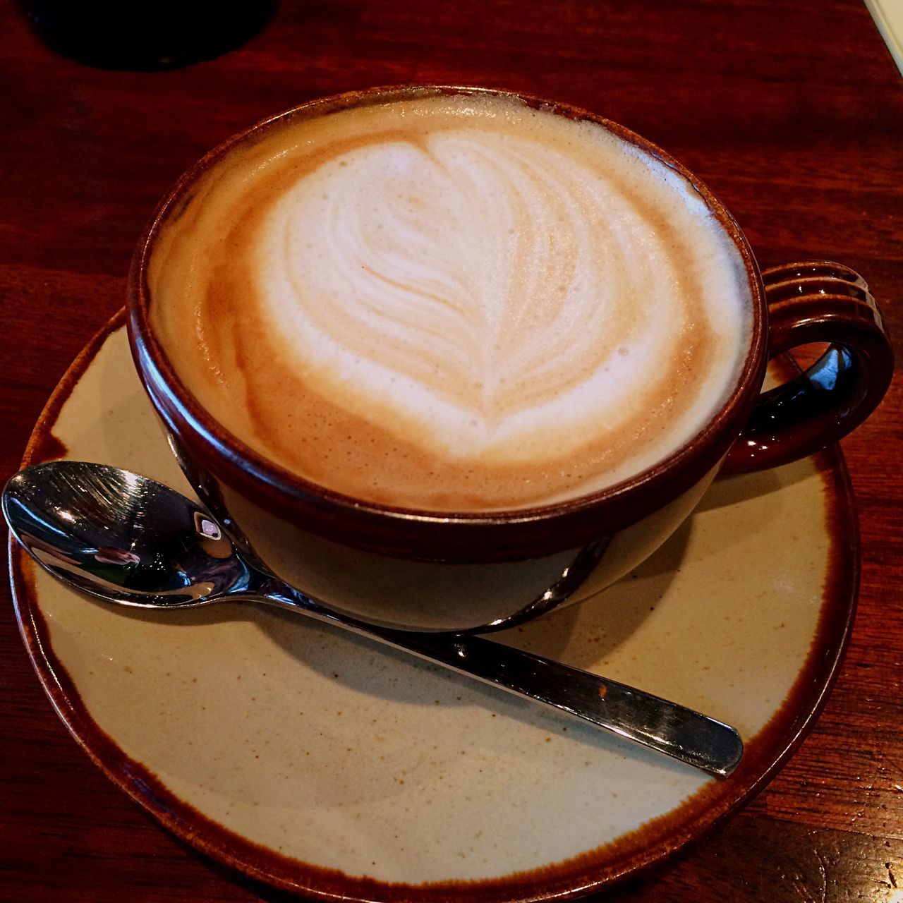 coffee cup, drink, froth art, food and drink, coffee - drink, saucer, refreshment, cappuccino, frothy drink, table, indoors, coffee, freshness, still life, latte, close-up, high angle view, cup, spoon, heart shape