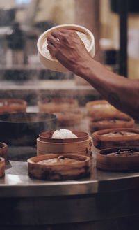 Cropped hand of chef preparing food in kitchen