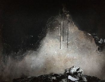 Panoramic view of icicles on rock at night