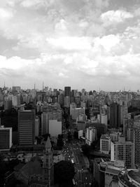 Cityscape against cloudy sky