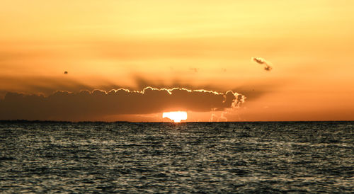 Scenic view of sea against orange sky