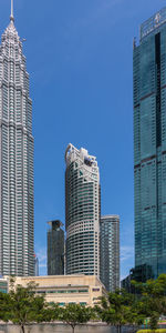 Low angle view of buildings against blue sky