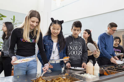 Teenagers choosing food in school canteen