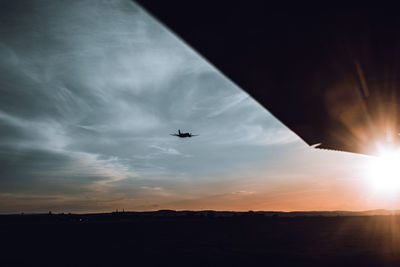 Silhouette airplane against sky