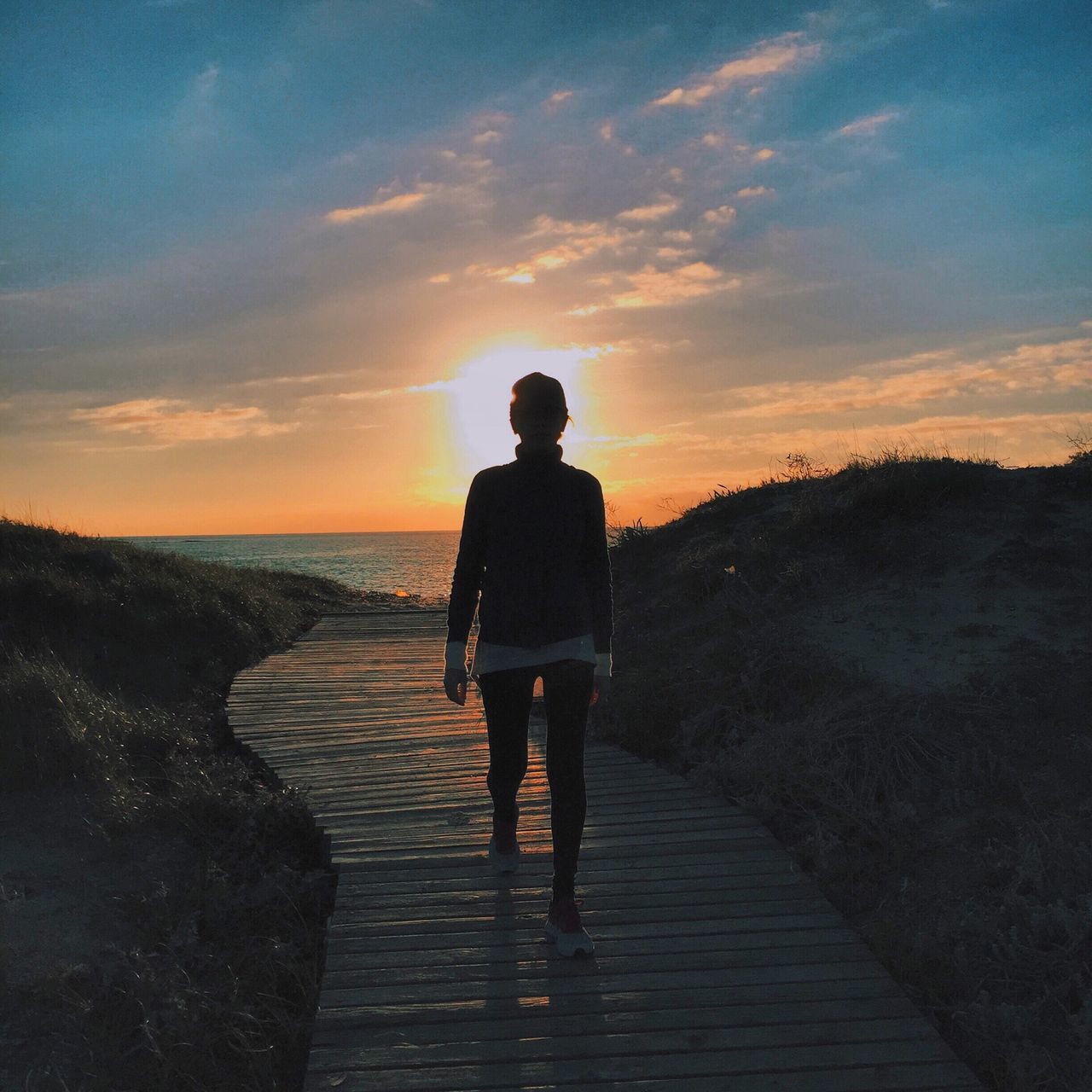 sunset, sea, sky, water, horizon over water, tranquil scene, tranquility, scenics, rear view, beauty in nature, beach, silhouette, standing, lifestyles, nature, cloud - sky, idyllic, the way forward